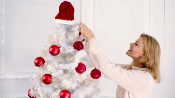 Feliz Ano Novo. Preparando-se para o ano novo e feriados de Natal. Mulher bonita feliz decora a árvore de Natal. Ano Novo e férias de Natal . — Vídeo de Stock