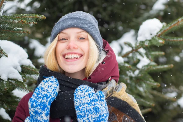 Γυναίκα ξανθά μαλλιά χαμογελαστό χιονισμένο φόντο φύση χειμώνα. Χριστούγεννα και Πρωτοχρονιά. Μοντέλο τρυφερό κορίτσι ζεστό κασκόλ καπέλο. Χειμερινή μόδα. Ευτυχισμένο κορίτσι που παίζει χειμωνιάτικη μέρα. Απολαμβάνοντας το χειμώνα — Φωτογραφία Αρχείου