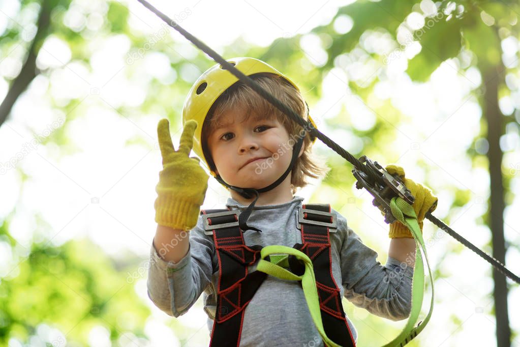 Children summer activities. Kid climbing trees in park. Children fun. Cute baby boy playing. Every childhood matters.