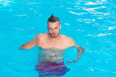 Açık yüzme havuzunda dinlenen yakışıklı adam. Bahamalar'da Karayip Denizi'nde seksi adam. Okyanus su arka plan - heyecanlı. Genç adam aktif eğlence - yüzme havuzu kavramı.