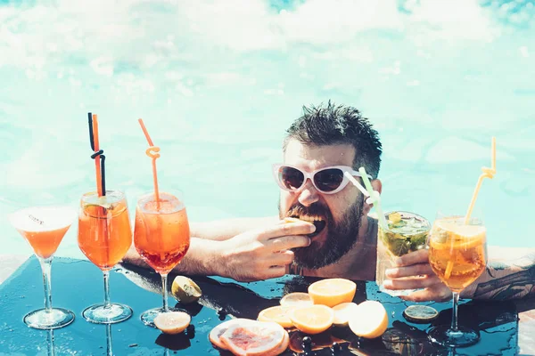 man drinking cocktail at the beach. Fresh fruits in Summertime. Good day of Happy man. Vacation concept.