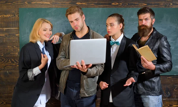 Bearded man masculine women and handsome guy school colleagues. Teaching and education occupation. Diversity concept. School staff. People with laptop book stand in school classroom. School teachers