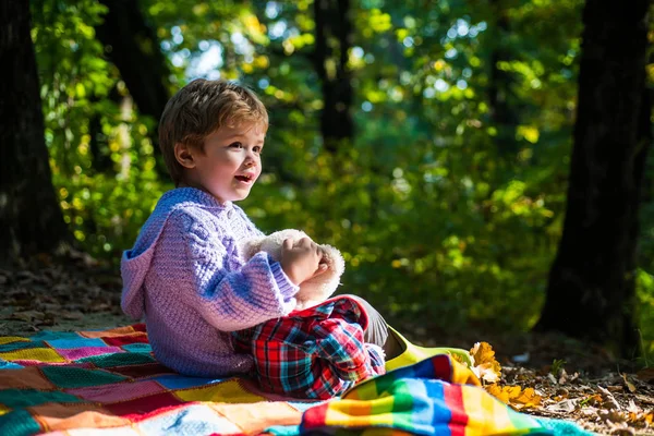 Better together. Happy childhood. Inseparable with toy. Boy cute child play with teddy bear toy forest background. Child took favorite toy to nature. Picnic with teddy bear. Hiking with favorite toy