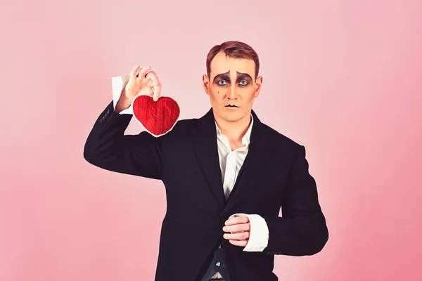 I love melancholy. Mime actor with love symbol. Mime man hold red heart for valentines day. Theatre actor pantomime falling in love. Love confession on valentines day