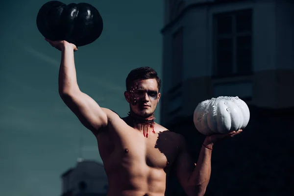 Uomo di Halloween con zucca per strada. Il giorno dei morti. Halloween. Morte - giovane ritratto di Halloween. Lo zombie spaventoso è in strada con la zucca. Che figo. Fitness — Foto Stock