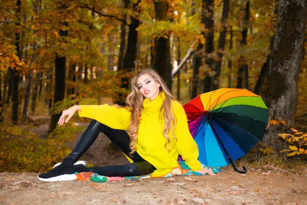 Beautiful Autumn Woman with Autumn Leaves on Fall Nature Background. Cheerful beautiful girl in red sweater outdoors on beautiful fall day. Happy girl on autumn walk. — Stock Photo, Image