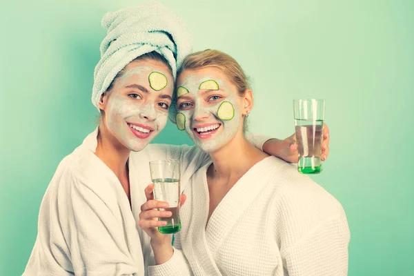 Girls friends sisters making clay facial mask. Anti age mask. Stay beautiful. Skin care for all ages. Women having fun cucumber skin mask. Relax concept. Beauty begins from inside. Spa and wellness — Stock Photo, Image