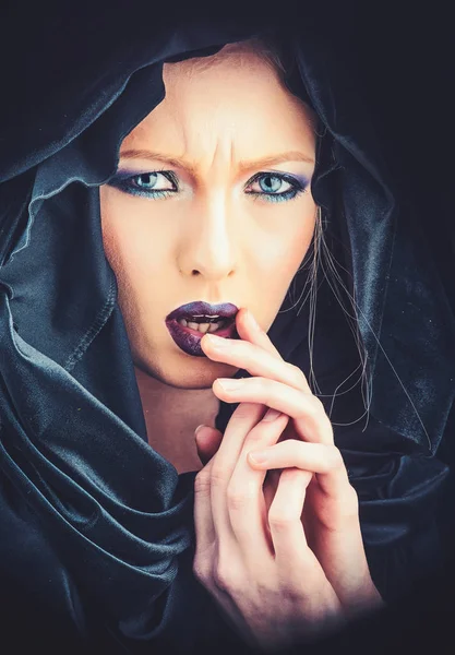 Gothic fashion and beauty. gothic woman in black hood with stylish makeup.