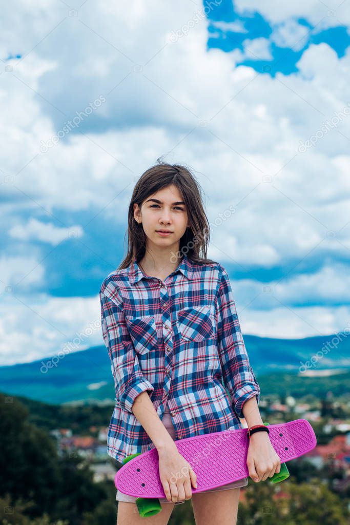 Hipster girl with penny board. Urban scene, city life. skateboard sport hobby. Summer activity. plastic mini cruiser board. Spring. ready to ride on the street. Why walk if you can skate
