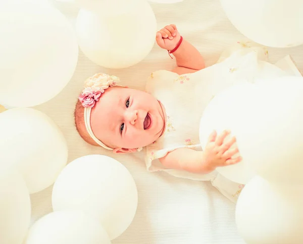 Pure happiness. Family. Child care. Childrens day. Small girl. Happy birthday. Sweet little baby. New life and birth. Portrait of happy little child in white balloons. Childhood happiness
