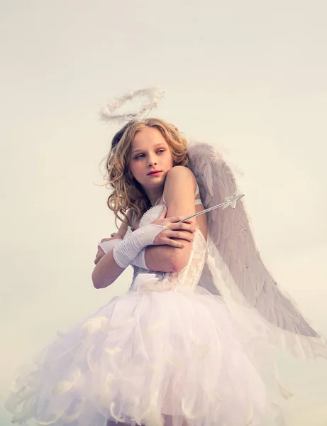 Real fairy from magical stories. Lovely girl cupid is ready to find your love. Little girl with angel wings and halo. Toddler girl wearing angel costume white dress and feather wings. Sweet angel girl