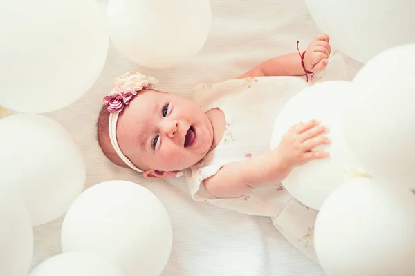 Pure beauty. Small girl. Happy birthday. Portrait of happy little child in white balloons. Sweet little baby. New life and birth. Childhood happiness. Family. Child care. Childrens day — Stock Photo, Image