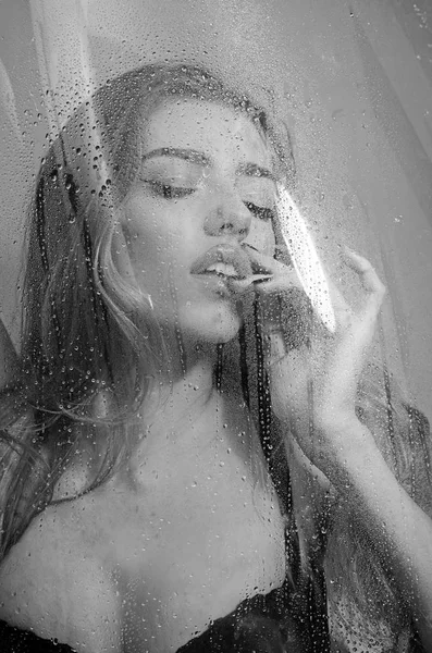 Showering woman shot from behind glass with closed eyes. — Stock Photo, Image