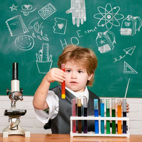 De genomförde ett nytt experiment i kemi. Kid lär sig i klass på bakgrund av Blackboard. Kunskaps dag. Skolpojke. 1 september. — Stockfoto