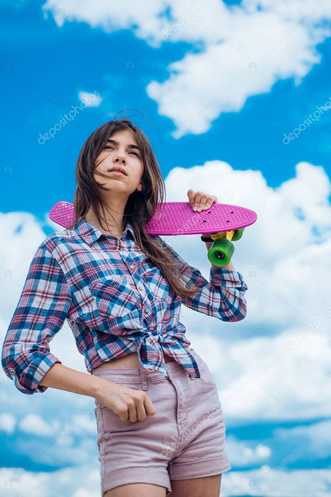 plastic mini cruiser board. Spring. Urban scene, city life. skateboard sport hobby. Summer activity. ready to ride on the street. Hipster girl with penny board. Her favorite mode of transport