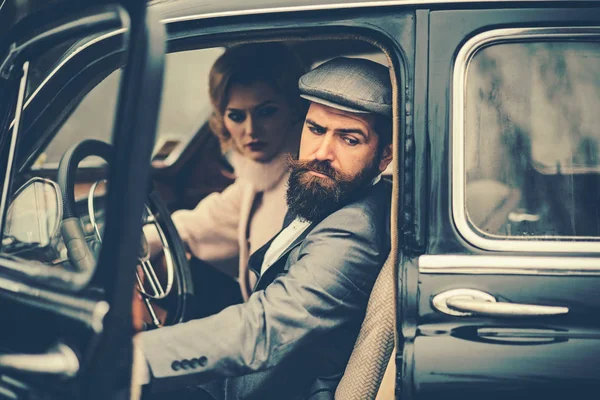 Travel and business trip or hitch hiking. Retro collection car and auto repair by mechanic driver. Couple in love on romantic date. Bearded man and sexy woman in fur coat. Escort of girl by security.