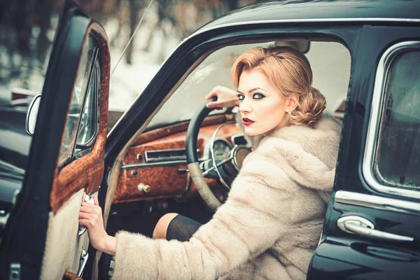 Escort and security guard for luxury woman. sexy woman in fur coat. Call girl in vintage car. Retro collection car and auto repair by driver. Travel and business trip or hitch hiking