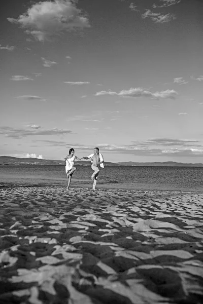 Couple in love dance on beach sand. Family and valentines day. Summer holidays and travel vacation. Sexy woman and man at sea. Love relations of dancing couple enjoying summer day together