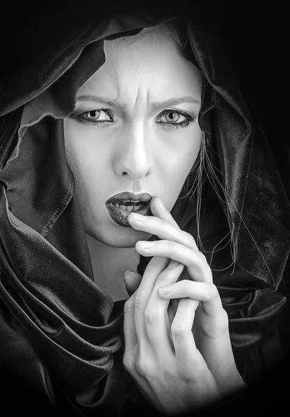 Gothic fashion and beauty. gothic woman in black hood with stylish makeup.