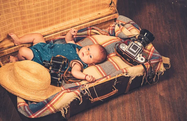 Multiple tasks. Portrait of happy little child. Sweet little baby. New life and birth. Family. Child care. Small girl in suitcase. Traveling and adventure. Childhood happiness. Photo journalist