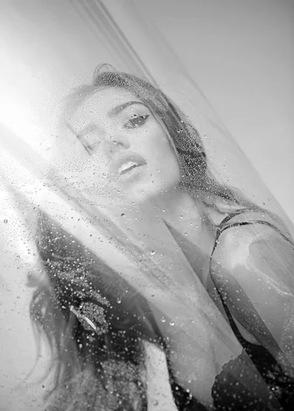 Girl in the shower for the wet glass. — Stock Photo, Image