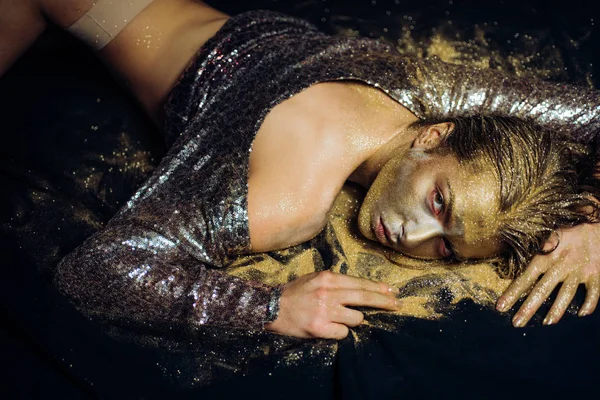 Golden skin. Sexy girl face makeup body art metallized color. Spa wellness. Richness and wellbeing. Golden mask. Luxury beauty procedure. Golden lady relaxing. Pure gold. Vogue and glamour concept