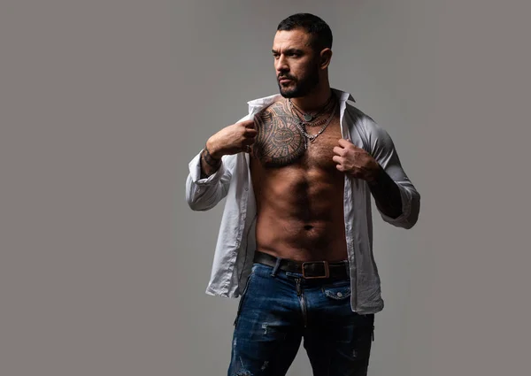 Charming and confident. Handsome latino man. Muscular man. Hispanic man with six pack abs. Athletic man with fit torso putting on shirt — Stock Photo, Image