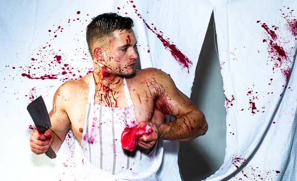 Letting blood. Butcher chopping bloody meat bleeding with red blood. Strong man cutting raw meat splashing with blood stains. Taste of blood — Stock Photo, Image