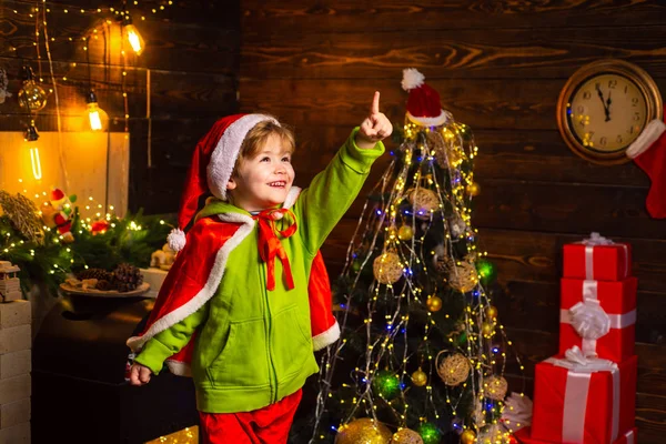 Home filled with joy and love. Best wishes for you your family this christmas. Merry christmas and happy new year. Cute little child boy play near christmas tree. Kid enjoy winter holiday at home