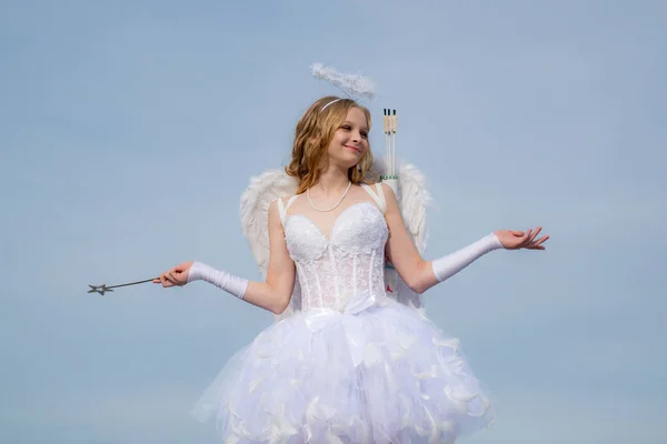 Little angel girl against sunny sky. Valentines day card. Happy teenage angel girl. Angel children girl with white wings. Pretty teen girl.