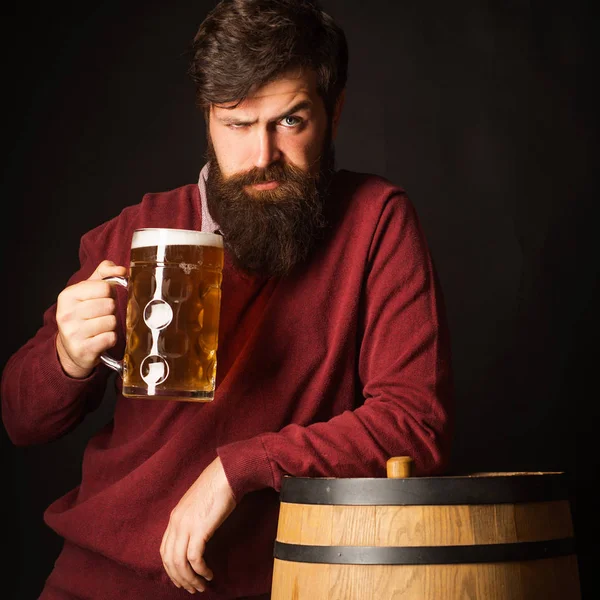 Beer Types and Styles. Bearded man with a glass of beer. Retro man with a beer. Brewery concept. Equipment for the preparation of beer.