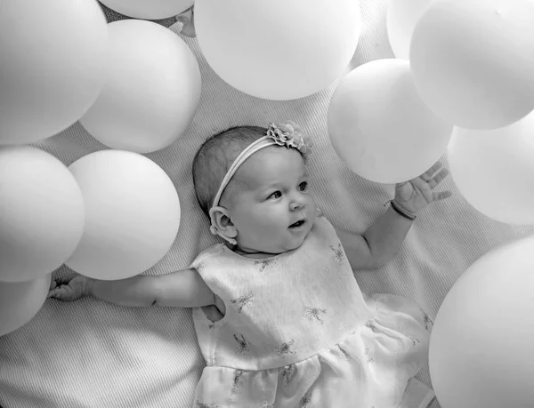 Little baby. Family. Child care. Childrens day. Small girl. Happy birthday. Sweet little baby. New life and birth. Portrait of happy little child in white balloons. Childhood happiness