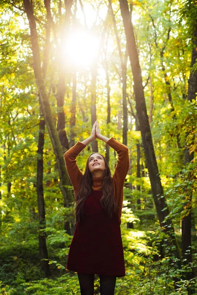 Pray mother nature. Woman enjoy nature alone. Nature is source of power for her. Natural beauty. Autumnal melancholy. Pretty woman stand nature forest background. Fall fashion. Enjoy fall season