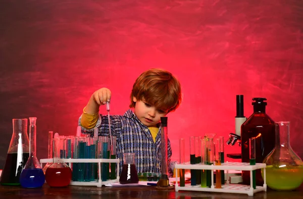 Child in the class room with blackboard on background. Little children at school lesson. — Stock Photo, Image