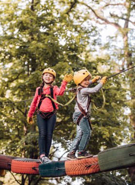 Çocuk oyun alanında oynuyor. Denge kiriş ve halat köprüler. Maymun Macerası'na git. Güvenlik ekipmanları içinde halat park kız Yürüyüş. Macera yüksek tel park tırmanma. Çocuk kavramı.
