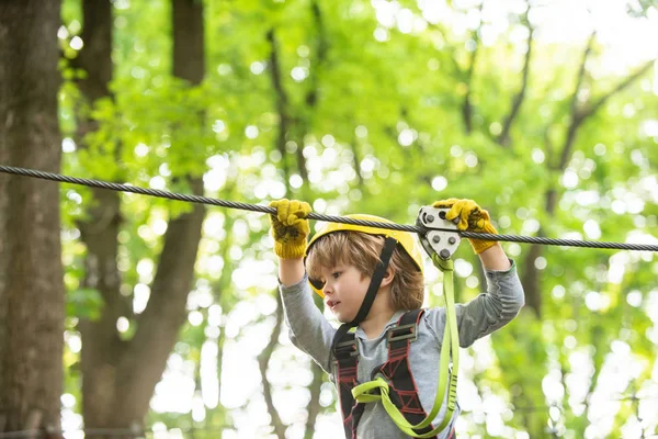 Adventure climbing high wire park. Artworks depict games at eco resort which includes flying fox or spider net. Every childhood matters. Kid climbing trees in park