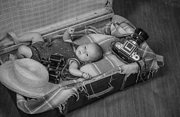 Multiple tasks. Portrait of happy little child. Sweet little baby. New life and birth. Family. Child care. Small girl in suitcase. Traveling and adventure. Childhood happiness. Photo journalist