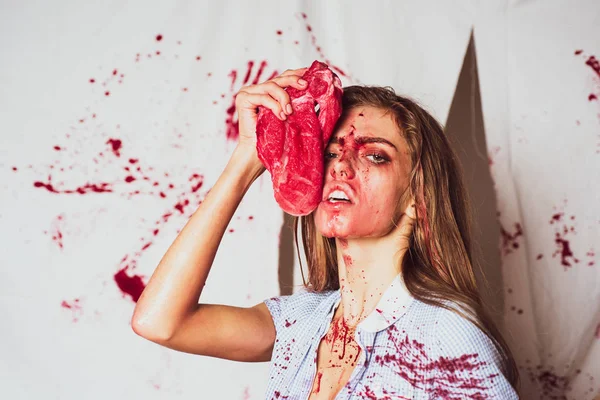 Dependence on acute sensations. Steak or beefsteak - bloody meat. Sexy woman covered in blood holding knife. Revenge of the lover. Toxics relationship concept. — Stock Photo, Image