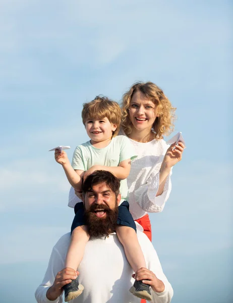 Heureuse famille joyeuse s'amuser vomit dans l'air petit garçon enfant. Joyeux famille avec enfant sur le terrain d'été - rêve de concept de vol. Bonne famille en vacances . — Photo