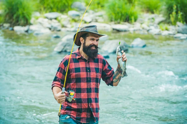 Bass pesca. Pescador e truta troféu. Rio cinzento no anzol. pesca desportiva. Método de captura de truta. A pescar. Pescando isca. Trutas . — Fotografia de Stock