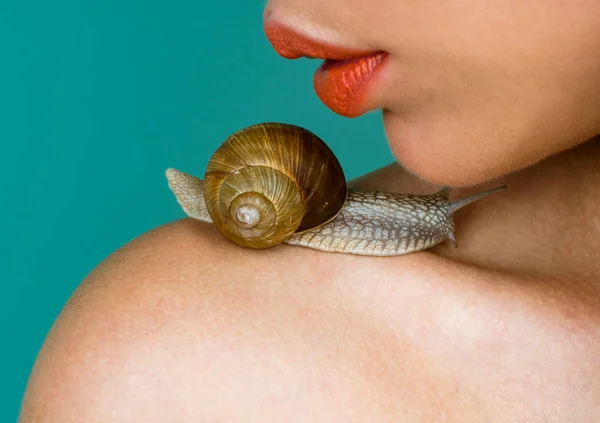Cosmetics and snail mucus. Cosmetology beauty procedure. Girl and cute snail. Skin care. Massage with snail. Skincare repairing. Healing mucus. Having fun with adorable snail. Spa and wellness