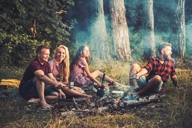 Ormanda kamp gençler grubu. İki çiftler üzerinde kamp ateşi Sosis kızartma. Arama, arkadaş karşılama adam heyecanlı. Adam kız arkadaşı kupa çay içme iken yemek yemek
