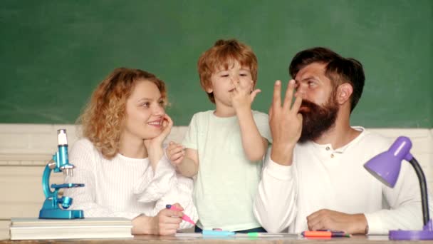 Bildungsmathematik-Konzept der Eltern. kleiner Schulbub in der ersten Klasse. zurück zur Schule und zum Schulbesuch. Familienerziehungs- und Datenschutzgesetz. junge glückliche Familie Schulbildung Mathe — Stockvideo