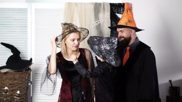 Family in costumes getting ready for halloween. Child boy tells his parents terrible stories on Halloween. Trick or treat. Halloween party. Cute family. Family in costumes. Background. Happy holidays. — Stock Video