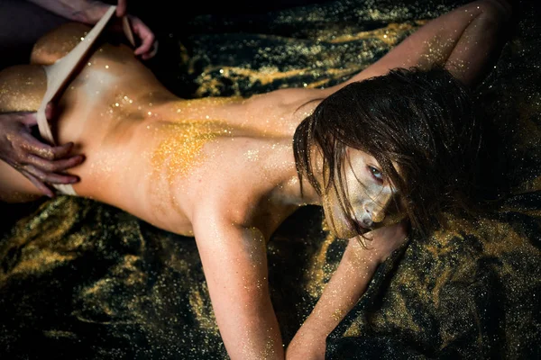 Golden meisje seksuele voorspel. Hou van seks. Gouden regels van geslacht voorspel. Hot booty meisje Undressed door mannelijke hand. Aantrekkelijke vrouwelijke billen. Sexy naakte meisje huid gemetalliseerde kleur lag ontspannen. Sex Pleasure — Stockfoto