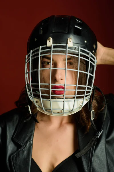 Sexy woman with American football helmet. Safety and protection. Protective grid on face. Sport upbringing and career