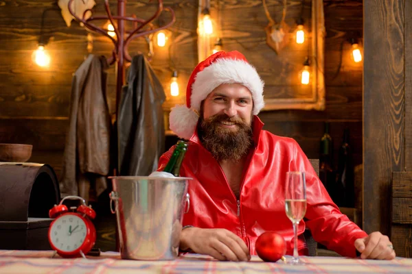 Christmas holiday. Lonely on christmas eve. Happy new year. Time to drink. Manly brutal santa leather jacket. Brutal santa claus. Man bearded hipster santa with red hat celebrate with champagne drink