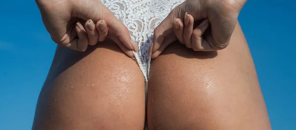 Womans buttocks in white lingerie. Firm buttocks in bikini underwear. Big sexy sandy buttocks. Sexy girl with big bum. — Stock Photo, Image