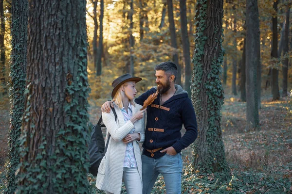 People in love on Autumn background. Outdoor Autumn atmospheric moments and dream. Autumn love story - portrait couple in love. Autumn couple. Romantic and love.