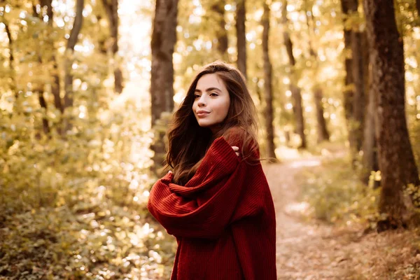 Jovem despreocupada em pulôver vermelho vintage na moda ou suéter. Mulher bonita andando no parque e apreciando a bela natureza do outono . — Fotografia de Stock